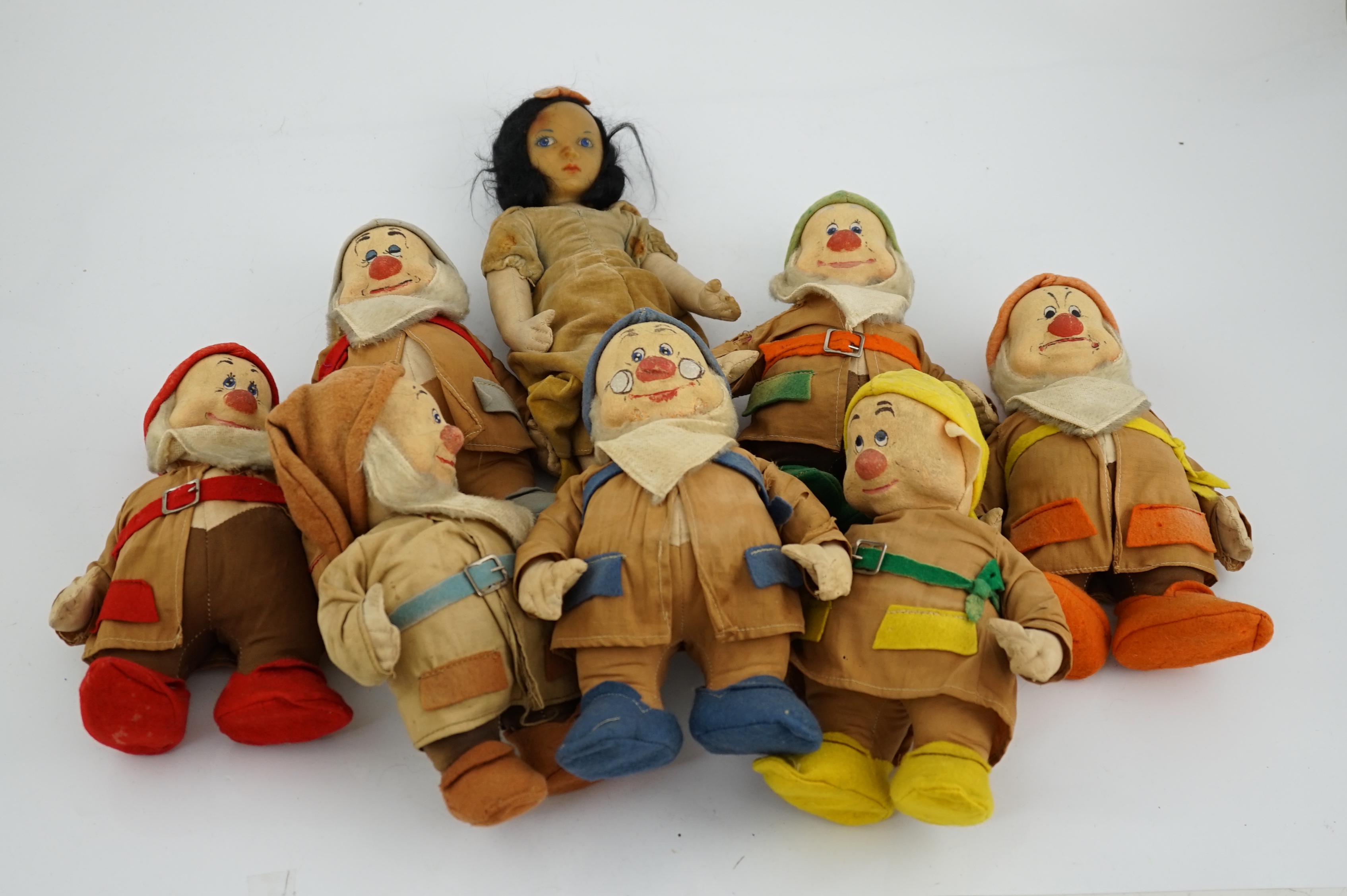 A set of Merrythought Snow White and the Seven Dwarves, Snow White with Merrythought label to the sole of her foot, the Dwarves could possibly be made by either Merrythought or Chad Valley, Snow White 36cm high